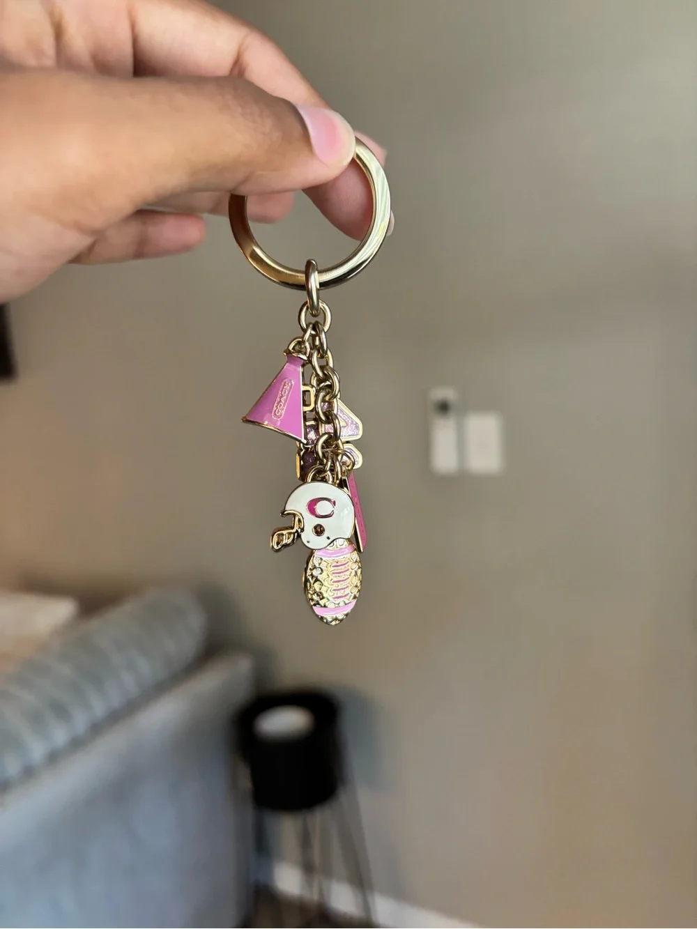 Coach Girly Football bag charm keychain in the champagne gold color